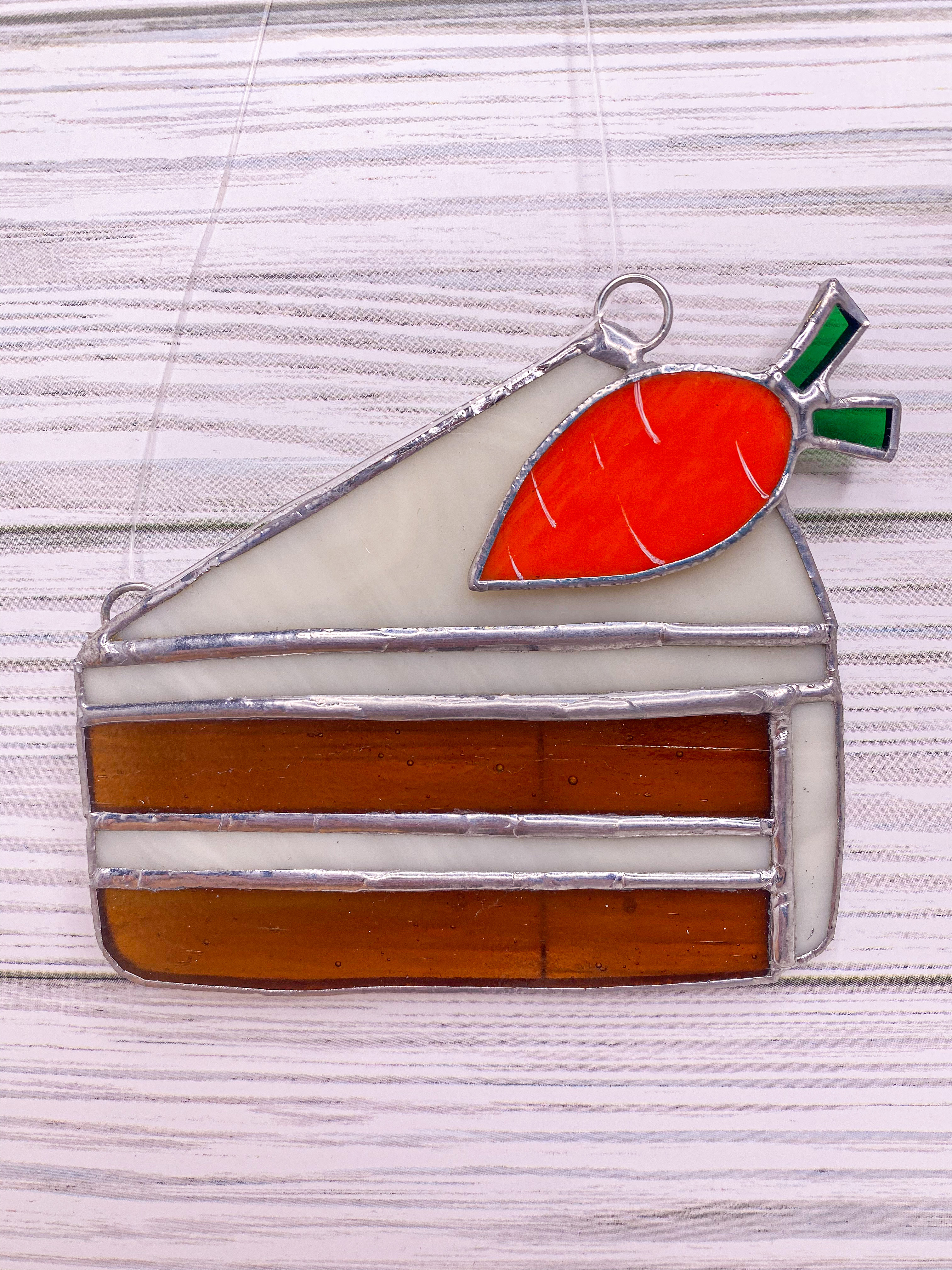 Stained glass carrot cake slice with a carrot on top