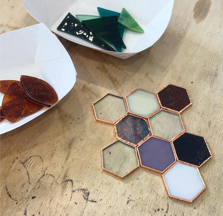 Copper-foiled stained glass hexagons in progress, with cut glass pieces