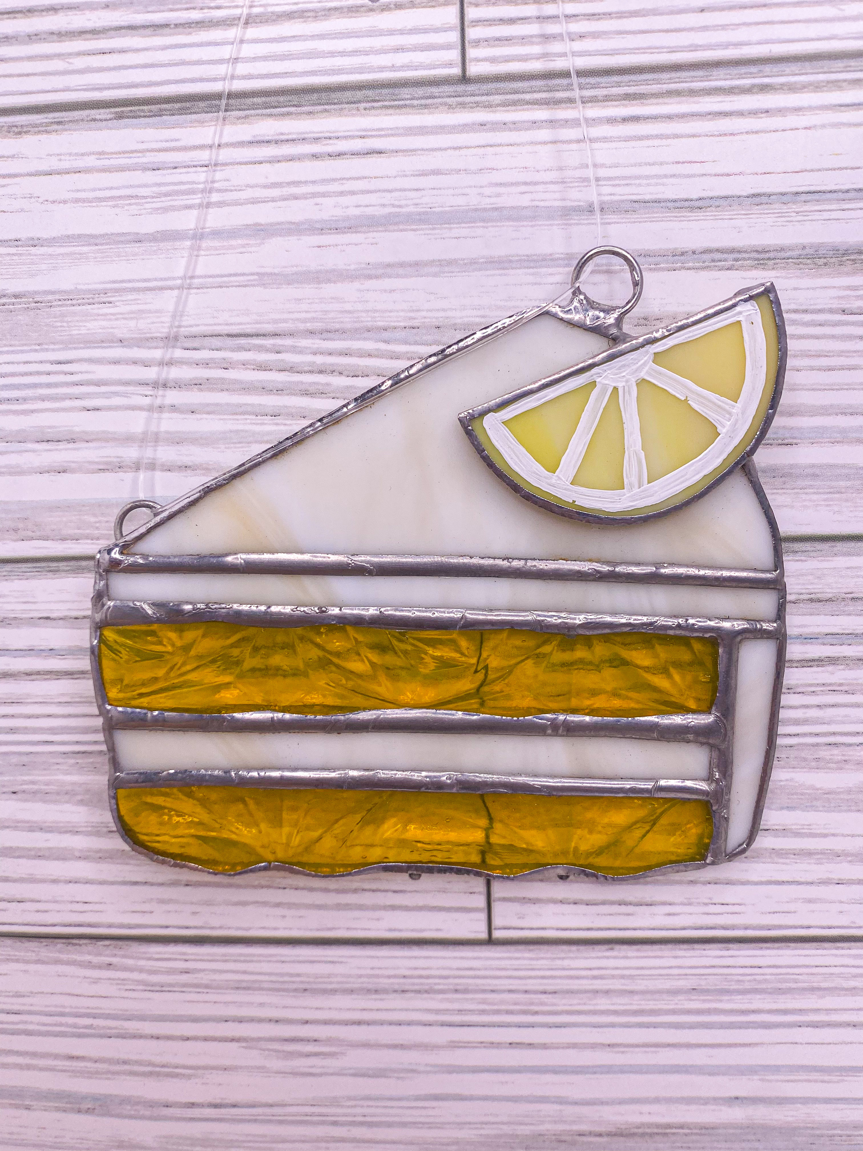 Stained glass lemon cake slice with a lemon wedge