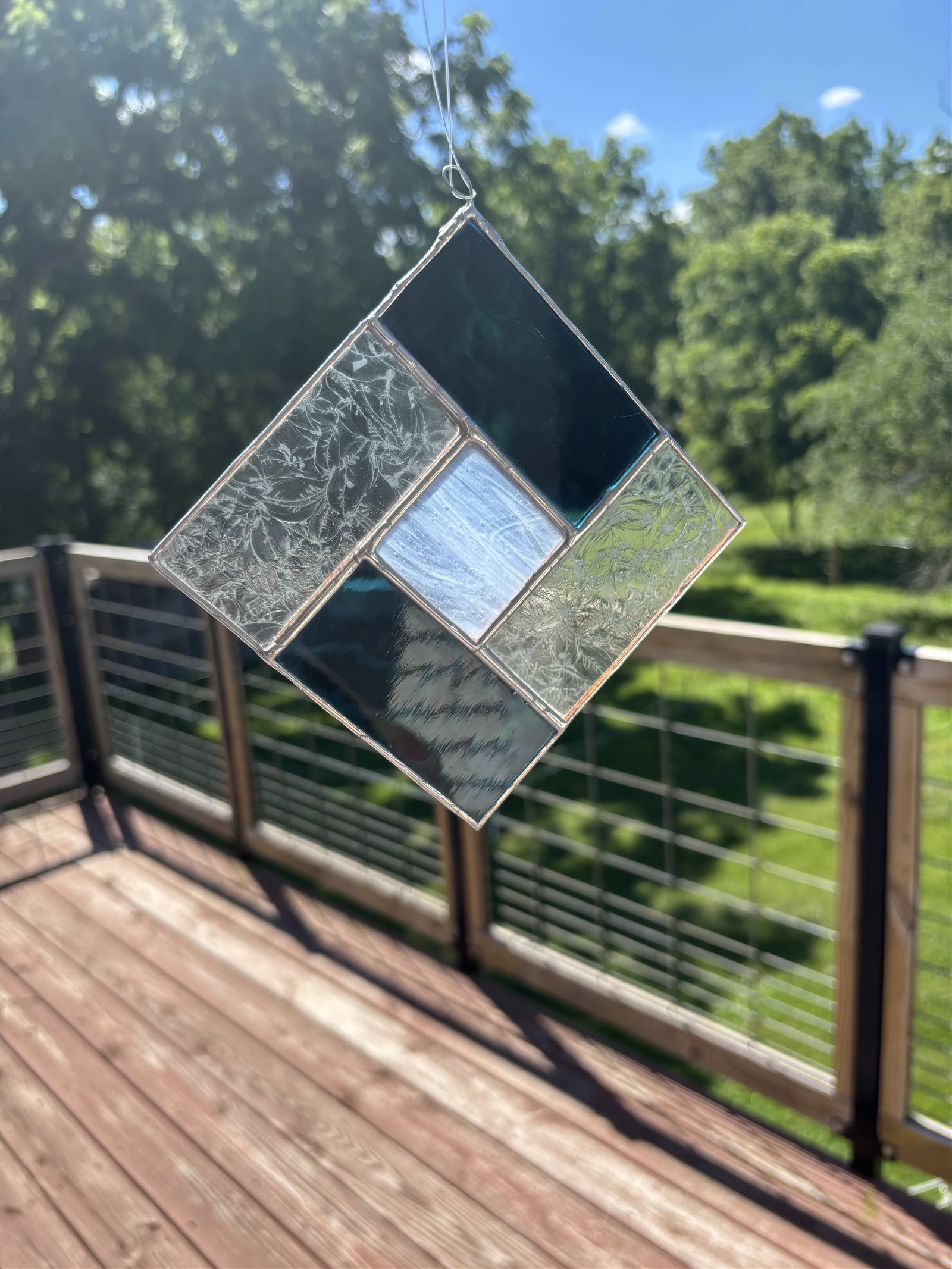 A finished Simple Suncatcher hanging outside, catching the sunlight