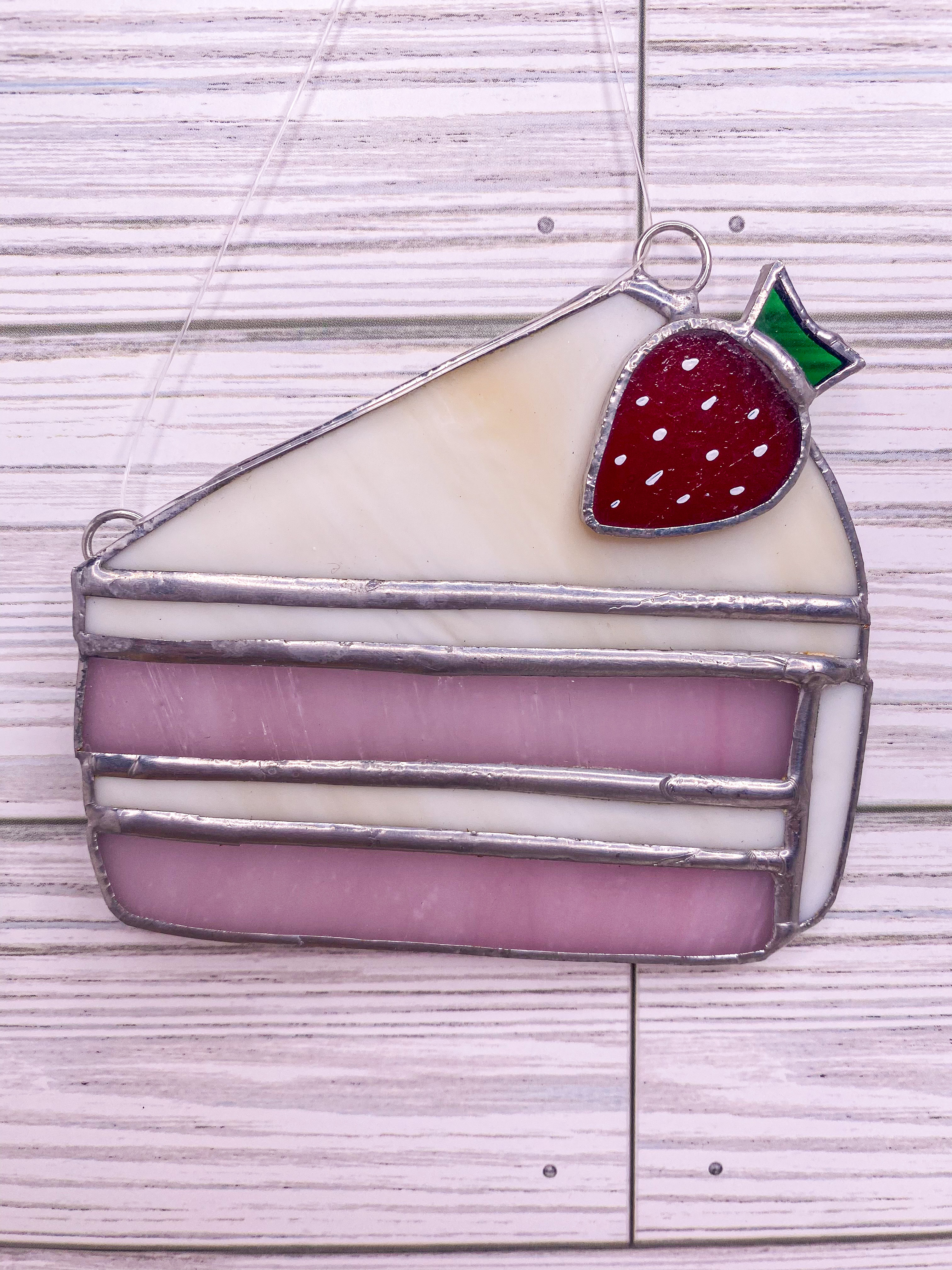 Stained glass strawberry cake slice with a strawberry on top
